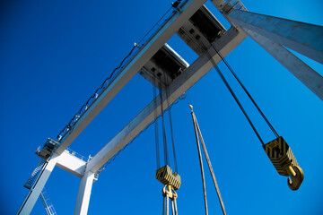 Harbor gantry crane moving a tank container