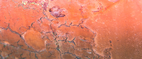 Old flaky paint peeling off on old wall, cracks and scrapes on the surface