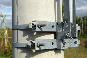 Clamps with fixing bolts on an electric pylon