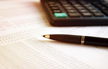 Business documents on an office desk with a calculator and pencil as a business concept of a workspace. With cloud exposure