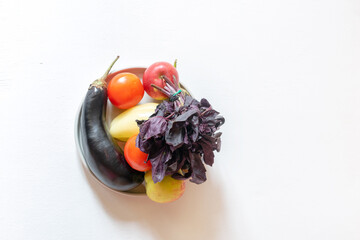 vegan healthy products on a plate on white background with copy space. fresh vegetables concept