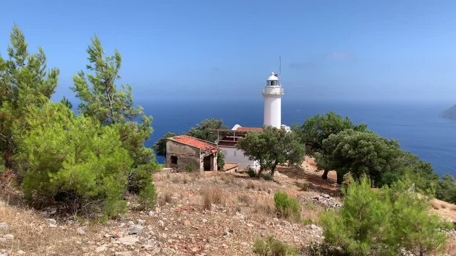 Famous Gelidonia (Gelidonya) Lighthouse in Antalya Turkey surrounded by olive and pine trees. Mediterranean sea and islands on a background. 4k stock video. 