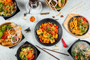 Fresh and delicius Vietnamese food table, Pho ga, pho bowls, noodles, spring rolls, asian dinner table on bright background