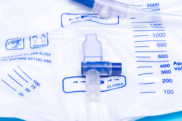 Sterile Urinary Drainage Bag with Anti-Reflux Tower isolated on blue background.