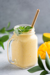 Fresh mango lassi in a glass jar. Healthy vegetarian mango smoothie