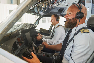 Confident pilots ready for the international flight in modern aircraft