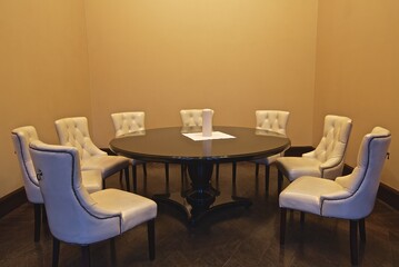 A round table and eight armchairs