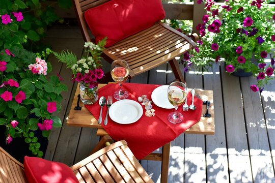 Outdoor al fresco patio table with beautiful place settings for relaxing dining on a warm summer evening 
