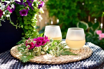 Relaxing afternoon in gorgeous backyard garden setting during stay at home summer vacation in secluded privacy to enjoy a refreshing glass of wine