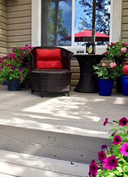 Backyard Deck Setting With Gorgeous Landscaped Private Yard And Flowering Planters For Relaxing On A Staycation Afternoon With A Book For Mindfulness Time