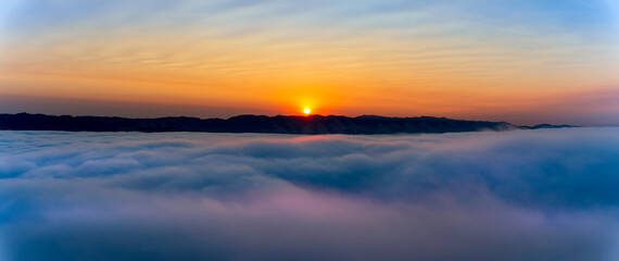 Fototapeta na wymiar Sunrise over Clouds, Valley, panorama 