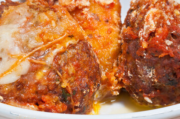 front view, close up of, two homemade meatballs with cheese in tomato sauce