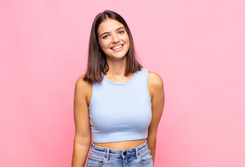 Fototapeta premium young pretty woman looking proud, confident, cool, cheeky and arrogant, smiling, feeling successful