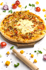 Delicious pizza with tomato, mushrooms, processed cheese on wooden plate
