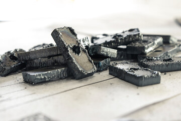 Metal blanks cut at a metallurgical plant. Iron items lie on a sheet of paper.