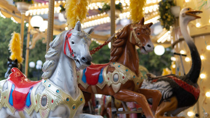 Fototapeta na wymiar Two horses in the foreground of a carousel.