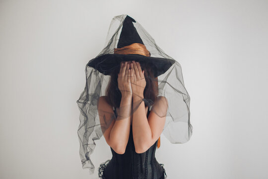 witch in old black hat and corset