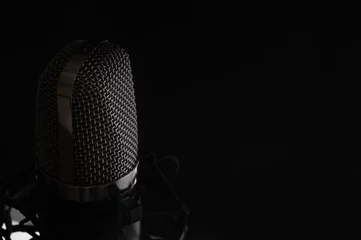 Gordijnen Studio condenser microphone isolated on black background. Music concept. Sound maker. © Anton