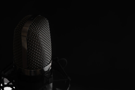 Studio condenser microphone isolated on black background. Music concept. Sound maker.