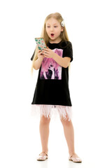 The girl is using a cell phone.The concept of people and technology.