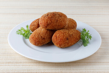portion of stuffed fried croquettes on a plate