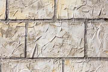 Abstract background stone concrete walls. Beige stone wall with thick cement, background close up displaying a range of colour tones and textures.