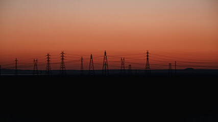 sunset over the city powerlines silhouette