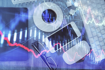 Multi exposure of forex graph hologram over desktop with phone. Top view. Mobile trade platform concept.