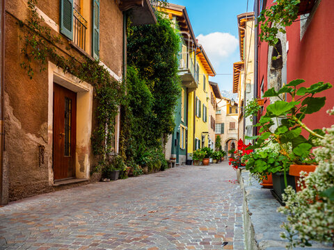 Fototapeta Wonderful glimpse of a colorful alley in the town of Mandello sul Lario, on Lake Como