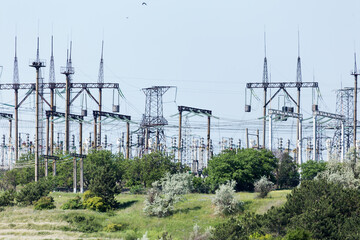 Power station, high voltage wires are against the sky. Power lines. High voltage power pylons