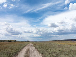 Rural landscape of blue sky in white clouds in the steppe near Odessa, hot summer day