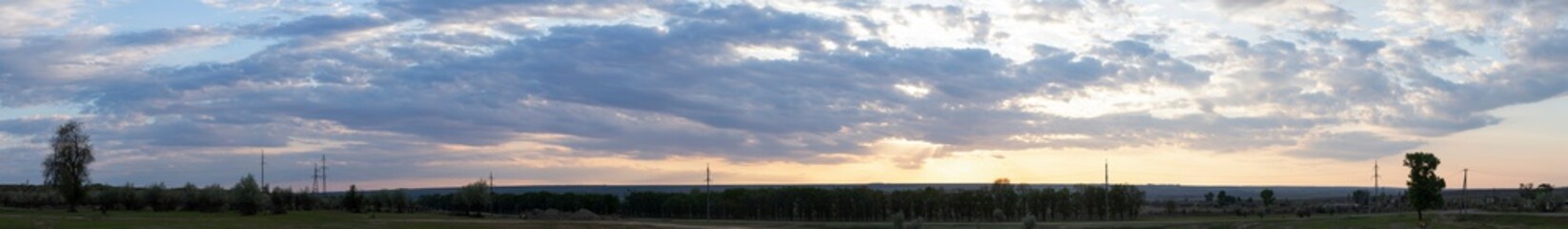 Obraz premium Landscape at sunset. Tragic gloomy sky. The village in the Budjak steppe. The terrain in southern Europe. Panorama.