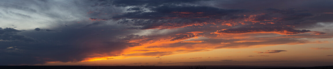 Purple-magenta clouds. Tragic gloomy sky. Landscape with bloody sunset. Fantastic skies on the planet earth. Twilight, nightfall.