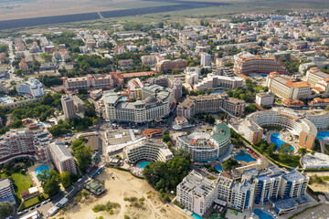 Suny Beach, Bulgaria - August 09, 2019: Aerial image a drone resort in Bulgaria on Black Sea coast. Many hotels and beaches with tourists, sunbeds and umbrellas. Sea travel destination. Travel