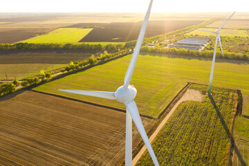 Aerial view on the windmills on the field, shot by drone. Renewal source of electricity. Wind...