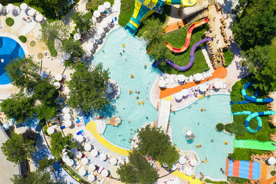Albena, Bulgaria - July 26, 2019: Aquapark view from above, people relaxing on a summer day. Aerial image a drone. Travel and vacation concept.