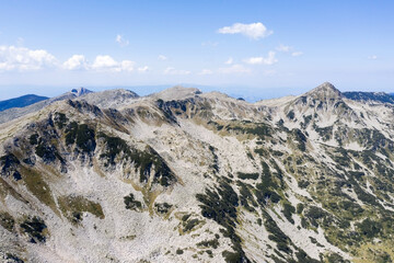 Aerial view from the drone. A stunning view of the mountain peaks in Bulgaria, shot from a drone in the morning at dawn. Travel and vacation concept.