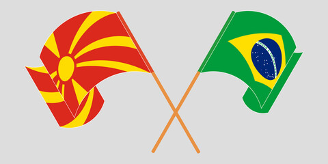 Crossed and waving flags of North Macedonia and Brazil
