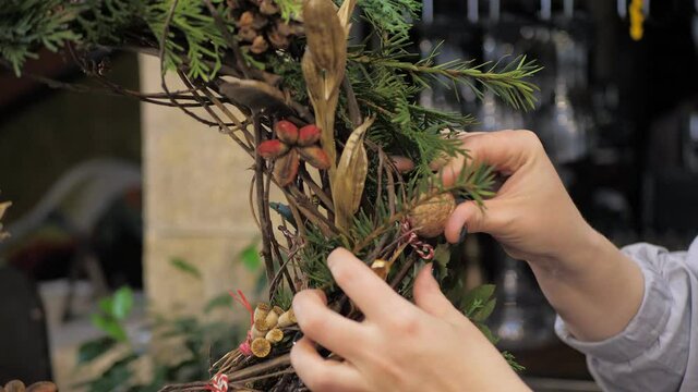 Florist at work. How to make christmas wreath with floral arrangement. Step by step, tutorial