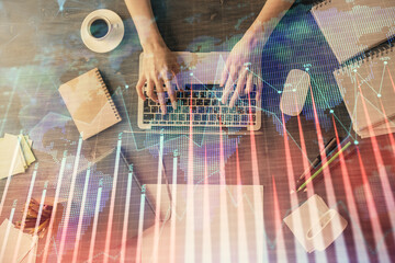 Multi exposure of woman hands working on computer and forex chart hologram drawing. Top View. Financial analysis concept.