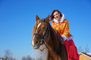 Woman in winter on a horse on a Sunny frosty day