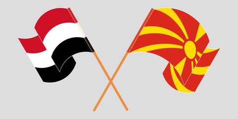 Crossed and waving flags of North Macedonia and Yemen
