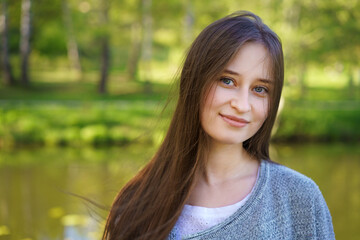 Portrait of a girl on a lake background