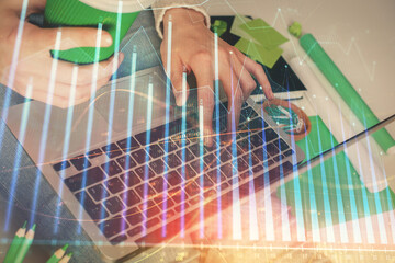 Double exposure of woman hands typing on computer and forex chart hologram drawing. Stock market invest concept.