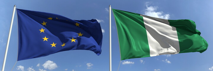 Flags of the European Union and Nigeria on flagpoles. 3d rendering