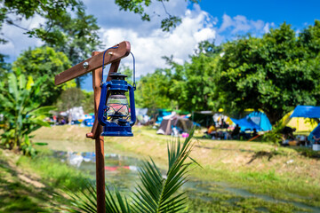 vintage lantern hanging on a wooden pole while camping