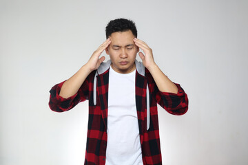 Young Asian man looked frustrated having a headache, stress expression. Close up portrait over