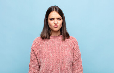 young pretty woman looking goofy and funny with a silly cross-eyed expression, joking and fooling...