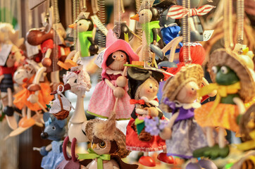 Colorful marionette witches for sale on the streets of Prague. Selective focus.