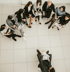 top view. the project Manager and the working group discussing financial data